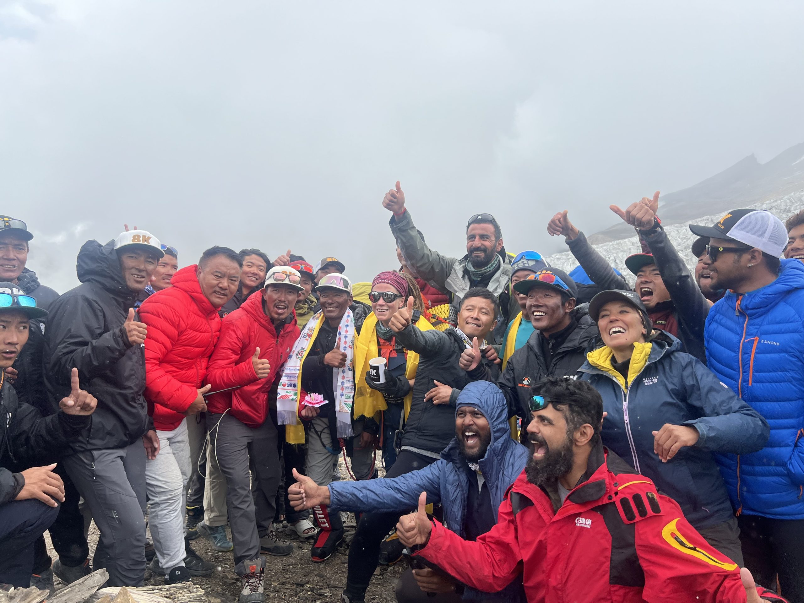 Large group of trekkers and Nima Adventure staff celebrating in the mountains
