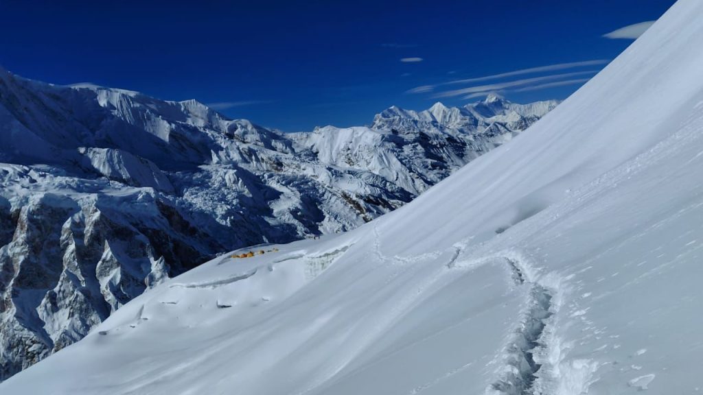 Footprints along a corniced snow ridge on Himlung Himal