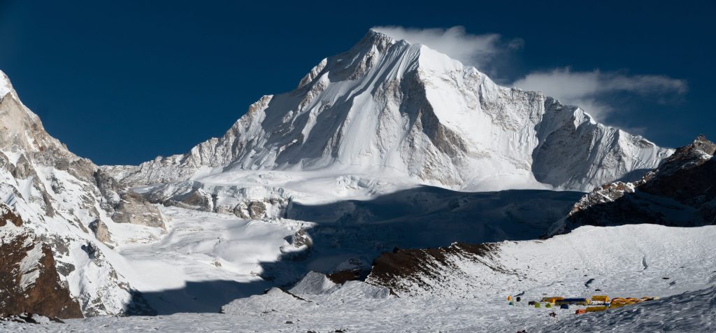 Broad snow-covered Himlung Himal above a high snowfield