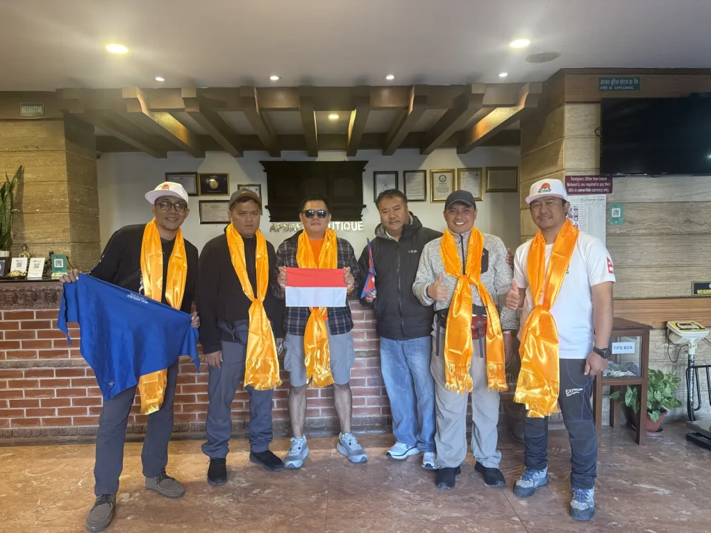 Trekking group with khata scarves at the Nima Adventure office