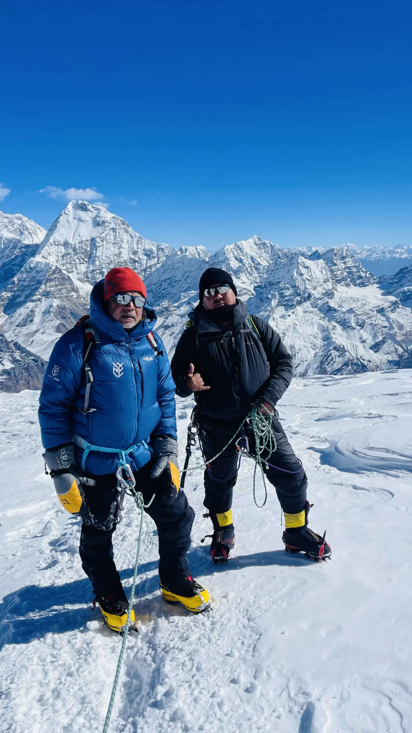 Two climbers on the snow of Mera Peak with Himalayan peaks behind