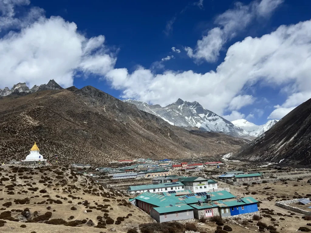 Teahouse village with a white chorten below Everest and Lhotse