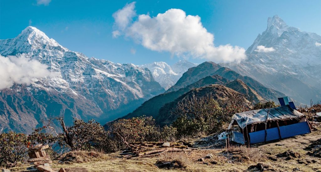 Machhapuchhre and Mardi Himal above a rocky trail and teahouse