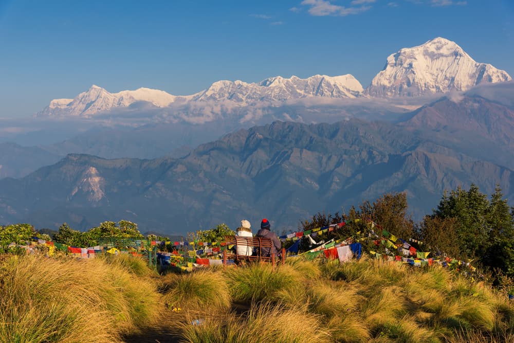 Trekkers watching Dhaulagiri and the Annapurna range from Poon Hill at sunrise