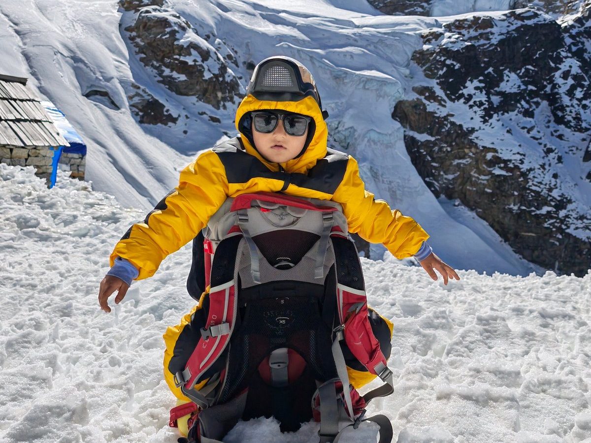 Anuj B’s four-year-old in a yellow down jacket on the snow during the Mera Peak expedition
