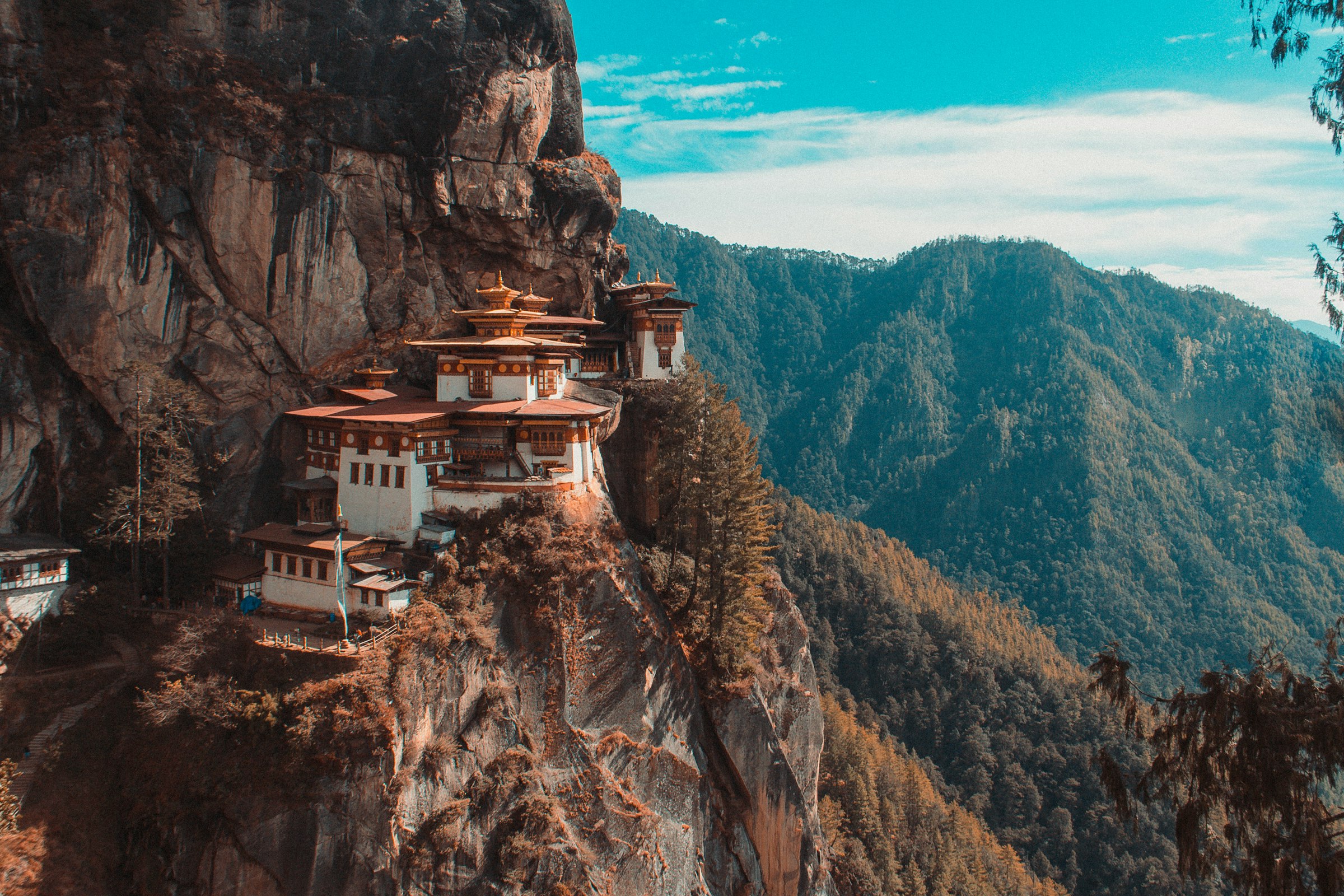 Tiger's Nest monastery perched on a sheer cliff above a forested valley in Paro