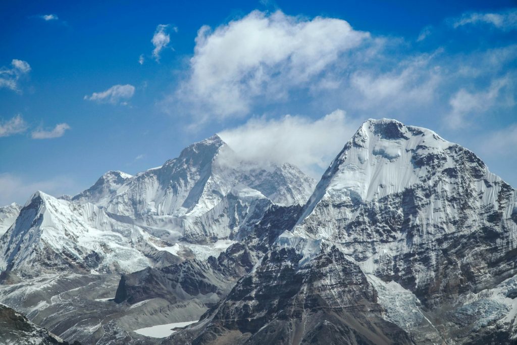 Massive snow and rock faces of high Himalayan peaks under scattered cloud in the Makalu region